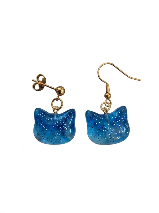 Blue glitter cat-shaped earrings on a white background