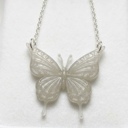 Silver butterfly necklace on a white background