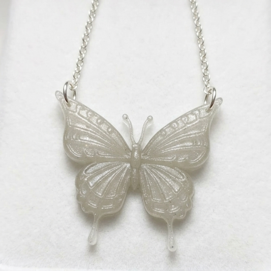 Silver butterfly necklace on a white background